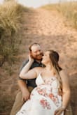 I wore this dress for our engagement photos and I loved it! It was a little bit tight on the bust, which doesn't usually happen with me. It made the dress a little low cut, but I still loved the way it felt and looked on me. Just be conscious if you are looking for something a little more covered. I am 5'4 and wore with sandals and the length was great. - Hannah B.