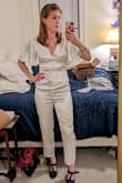 Really like this jumpsuit and it ALMOST fit well. As some other reviewers noted it was strangely baggy in the waist, but otherwise quite snug all around, so I don't think changing size in either direction would help. If I lift my arms the slack in the waist goes away, and there is very little stretch (if any) in the material, so altering it to remove the extra fabric in the waist would probably end up with it ripping at some point. Thought it was very comfortable and cute so I am sad to return :( For reference I am normally a small in tops, a 28 in jeans, and a 6 in dresses and purchased a small. - Katherine B.