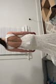 I am completely in love with this dress. It's just as gorgeous as the overpriced versions of similar wedding dresses, but this one is actually comfortable. It's soft to the touch, doesn't wrinkle, and fits snugly in all the right places. I got a small - I wear size small in all clothing - but I am a bit on the muscular side. For ladies on the slim side, I would say to go smaller. I will probably need slight alterations in the halter part of the dress, but that's bc I have a shorter torso. Otherwise, the dress is proportioned well and fits like a glove. My wedding is still a few months away so I'm eager to see how the train works out (it's quite long) but I highly recommend this dress. - Katie B.