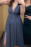 I loved this dress. It didn't look quite like the color it was in the pictures. I was expecting a dark grey but it is actually like purple/blue and the color looks very different in different lighting. I probably should have gone with an XS because the bust was still quite loose. It was fine because had my sister take it in a bit up top. It was also a little long but I wore tall heels so it wasn't an issue with my outfit. It was so much fun to dance in with the flowy bottom and the slit leg. And it was totally appropriate for both the ceremony and the reception. - Kylie C.