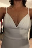I'm short waisted- which is why I think this dress didn't fit. The dress was snug around my body. The material was thick enough not to show cellulite. I probably would have kept the dress but I had to cinch the straps so high to fit that it just looked tacky. - Scarlett M.