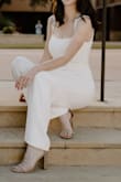 This jumpsuit was great for my graduation pictures! I am 5'9" without heels and could still wear a 3in heels with it, and it does not look short. The only difficulty I had was finding the correct bra, so the straps didn't show at the sides, and zipping it up in the back. I like to think that I am pretty flexible, but it was still a task! The material is thick and doubled, but you still need to wear nude undergarments to prevent showing through the material. - Rachael B.