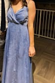 The color is gorgeous! The material also has a nice texture to make it more unique. It looks great freshly steamed but does crease a little bit if you're sitting down, getting in and out of cars, etc. I wore it to a February wedding and got tons of compliments! - Kenzie M.