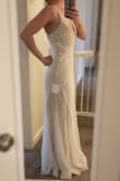 As soon as I put this dress on I *knew* it was the one. Even taking it out of the packaging I was so impressed and excited. The beading is absolutely beautiful and of great quality. The placement is so flattering. I'm in love. The straps are adjustable and maybe a little on the thin side. It has a simple tan lining which I love. I will need to have it hemmed a few inches but I am 5'5 and plan to wear flat shoes. If you're considering this dress - BUY IT! You can always return it if you don't like it. ;) - Lindsey B.