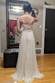 If you want a 'traditional' but simple wedding dress, I think this is it. The skirt is really heavy and nice, and I loved the inner silk layer, so comfortable!
It flattered the silhouette rather better than you see in the photo, but I think I would have wanted it tailored. It was definitely long and would have needed hemming. - Esther C.