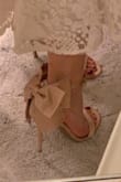 These shoes seemed like they were going to be perfect for all my bridal events but were unfortunately too uncomfortable to wear for more than 30 seconds! I could hardly walk 5 feet without the backs digging into my ankles. I don't think sizing up would have helped because the back is so structured, it would have been too loose. The strap across the toes was also a very uncomfortable fabric, almost scratchy. Some of the reviews I read didn't like the bow quality and I actually found it to be perfect, it was just as pictured, as was the pink color. Such a shame that they're virtually unwearable, because they're so so adorable! - Abbey M.