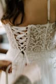 After trying on 5 wedding dresses for my elopement, this was the last one I ordered. The other reviews said it ran small...I usually wear a size 6, but ordered the biggest size (10) based on reviews. They were all right, it does run small. It fit perfectly everywhere except it wouldn't zip up completely in the back. I was really bummed and ready to send it back, when someone suggested I try to get it altered - adding a corset in the back. It worked, and turned out beautifully. I spent almost as much on the alteration as I did the dress, but absolutely loved this dress. Everything about it felt way more expensive than it was. It was super comfortable and flattering. If you love this dress and it doesn't fit, consider whether altering it would make it perfect for you. Obviously they need to size this better, but at the end of the day I was thrilled with my result and glad I didn't give up on it. I would have given this 5 stars if it fit off the bat. But giving it 4 because I had to alter it. - Jennifer N.