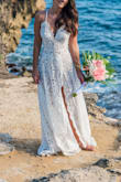 I loved this dress for my beach wedding. It looked beautiful, came out of the suitcase wrinkle-free, and the sand/saltwater came out easily. I did make a number of alterations. 1) I cut off all the little frills along the edges. 2) I needed a good 8 taken off. Instead of doing a straight hem like how the dress came, I followed the lace for an uneven hem that was shorter in the front and longer in the back to give the dress a bit of a train. 3) I shortened the straps and made them meet together in the front instead of about an inch apart. - Lexi M.