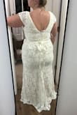 The only thing I would change about this dress is that I wish it was "whiter". It's definitely more of a beige cream color but the lace flower detail at the bust is gorgeous. I also wish it had a bit more length in the back. I'm 5'1 and am wearing 4-inch heels in this picture. I feel like it runs a tad small personally. I added a beaded belt and loved it. I will be wearing this for our small hometown ceremony we're having for my dad. I have a really expensive gown I'm wearing for our big out-of-town wedding. - Shelby W.