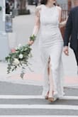If you are at all considering this dress and this style, order it! If it's not the right one, returns are easy. The price of this dress gave me room in my budget to splurge on other accessories and flowers for my elopement. I'm normally a medium but it was sold out, so I decided to try the small after seeing another reviewer say she wore a small while 5 months pregnant. Fit like a glove.
I altered it slightly by having the lining attached to the shell along the front slit. I also tried to have a bustle installed but the train is too heavy for it to work. A tailor more experienced in gowns might be able to figure it out. I would choose this dress again 100 times over. - Moo S.