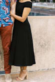 I ordered this for my engagement photos and hope to wear it again. I wore an underwire strapless bra and high-waisted Spanx that seemed to combine to create some rolls the dress loved to hug. I'm hoping I can figure something out in the future because this dress is very versatile. The material seems solid but a little too thin to dress up a lot, but I loved how our photos turned out! I didn't have an issue with the back, but I can see how that would happen. I loved that the dress wasn't tight at the bottom to allow a little movement. - Pooja S.