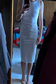Love this dress! It's a thicker material so it doesn't show too much. The low back has boning to keep it in place. Midi length is too long for flats but looks good with heels. Got it for my rehearsal dinner and it might be a bit much for that but keeping it for a fancy dinner out with my hubby! - Michaela O.
