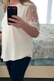 I bought this to wear to my bridal shower. It runs small across the chest and shoulders and the medium was too small. The large was sold out so I bought XL which is a little big on me, but the blouse is nice and flowy that I decided to keep it. The lace detail on the sleeve is really pretty and the blouse is lined so its not see through. - Marie J.
