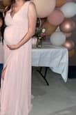 I sized up to use for my baby shower I was 8 months pregnant weighing 175 5'7. My stomach was very small (I had a tiny tiny baby.) This dress fit perfectly, a little big still but my stomach was small. - Stephanie G.