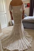 I said yes to this dress yesterday!! I will be wearing it for my June wedding, which will be outdoors so I wanted something that I would be comfortable in without overheating. You can't see my face in the pictures but I am BEAMING. The train is absolutely gorgeous and I feel like a total princess. I looked at a lot of lace dresses and I loved that this one was kind of a more modern take on lace, with a more geometric pattern instead of the typical flowers. I'm not wearing any shoes in the photo, but will probably need to get 2.5" heels to make sure I don't trip (I tried it on with 2" heels and the edge was right on the floor, so it may be just right for you taller ladies!). I will say I was on the edge about whether or not to order this, so if you're not quite sure yet just try it on! It's definitely worth ordering multiple dresses and then returning what you don't like. I'm really glad I took the chance because I can't imagine getting married in anything else! - Vanessa F.