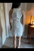 I found this dress while looking for a white dress for our daughter's graduation. She loves flowers and most crocheted things, so I gave it a shot. I knew her normal size since we shop Lulus often. I purchased her an XS and it was perfect. Not too loose and not so tight that it causes creasing or the fabric to roll. It hugs her like a glove, but not inappropriately. It is an amazing dress. You can't go wrong. I'll probably purchase it for her in other colors as well, but she wanted white for her high school graduation. I think this dress in different colors would be perfect for so many spring and summer events coming up. Don't mind the sports bra strap underneath in the pics.= She was just trying it on. Graduation hasn't happened yet. The pics are cropped because it wouldn't let me expand the pics, but you get the idea. Buy the dress! - Mildred Y.