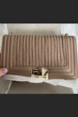 Very cute bag! The adjustable strap is really nice. It's a great size. Looks expensive. The color is much darker in person. I've attached pictures of the listing and my bag side by side to show. - Leah S.