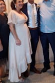 This was the Cinderella fit for me as a preggo bride. I felt like it hit all the right curves and hid some of my middle bulk with the front detail. I have a gigantic chest right now so that was the issue with the other 8 dresses I previously tried before finding this one. I had a small pin just to keep them from popping too much but it was tasteful and sexy at the same time. The quality of this dress was above and beyond for the price as well. Very happy with my purchase! - Kaitlin M.