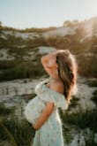 This dress is so beautiful! I thought it would be too long for my 4'11 height but it was perfect. I wore it at my 36 weeks and 6 days maternity shoot and was still able to squeeze into it. - Kamli S.