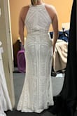 This dress was absolutely gorgeous and of high quality. The beading is amazing and the exact shape I was looking for. I ordered a large because, with my large bust, it is almost always a must. The dress fit well, except there was too much room still in the bust. I would have had to have the sides taken in for sure and maybe even the halter part shortened.  If I had time before my wedding, I would have ordered in a medium just to see if it fit better, but I am worried the hips would be too tight. If it comes in other colors, I will definitely order it again as a dress for me to wear to my stepdaughter's wedding. Probably have it altered.  Really beautiful!! Ps. I am standing on my tip toes in the pics, the dress would have been perfect or slightly long for me at 5' 5 1/2" with heels. - Barbara M.