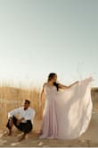 I knew for my engagement pictures I wanted a flowy lavender dress that would blow in the wind. This dress was made for that! The length was very long which was to be expected but I didn't need to get it altered for what I needed it for, the extra length just added to the extra flowy effect. I have a very wide back so the top of the zipper was snug but still very comfortable. It held up great even after hiking up the sand dunes and getting stuck on some branches along the way. I would definitely get it shortened and wear it again for an event. - Kristin P.