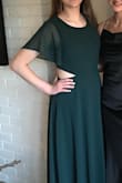 This dress fit my daughter well. She wears a size 10/12 generally and we ordered her a large. The waist cutouts are not "sexy" but really update the dress. It was great for prom, but I could easily see it work for a bridesmaid too. LOVE! - Patrick C.