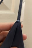 The strap broke when I was trying it on!! I ended up keeping it and fixing the strap myself and then reinforcing the other strap. Will be wearing it to a wedding in a few weeks. - Laura M.