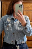I really loved the style of this jacket but found it much too large for me. I typically wear a medium in most Lulus dresses, but I like my denim jackets to be a bit more fitted (otherwise I look too boxy), so I specifically ordered a size small in this jacket to account for that. Even with a small, it was still too large and boxy on me. I could still fully button the jacket with room to spare, and the arms of the jacket were very boxy/wide cut in addition to the collar being wider than a normal denim jacket. I would have exchanged it for a XS if I could, but the sizing only goes to S. That said, I think the crop and distressing were great and overall quality for the price was just right. - Ashley L.