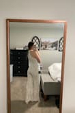 I'm short, so I didn't want to order a L and worry about it being too long! I ordered a M and it's pretty perfect! Still a little long, but I'll be wearing 3" heels. It's also a little tight on the bottom half, but that's because I'm pear-shaped. This also means the top is only slightly loose, again, because of my body shape. I wouldn't change the size I ordered! It's so beautiful and I can't wait to wear it after our wedding to go out downtown. - Julianne D.