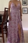 This is a beautiful spring dress. I loved the color and flow. It was long on me and I had to have it hemmed, but I am 5'2". The back has ties so you can adjust it to what you need. You can't see the slit in the picture but it has a large slit when you walk, not really exposed when standing. I wore it to an outdoor spring wedding.
One photo at the wedding. Other photo before alterations. I wanted to dance comfortably so I didn't want a train. - Crystal S.