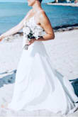 This dress is gorgeous and overall made of high quality. It ran a little long for me but kicked out just enough with heels.  The spaghetti straps are delicate but strong.

I wore this dress for my beach elopement and it looks great in the photos! It doesn't have a train but the extra length flowed with the wind and made the dress look full. 

Highly recommend for an affordable summer wedding dress. - Kayla B.
