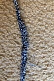 It arrived in the mail with two small holes, the fabric is very thin/cheap. Not worth the money. The strap wasnt even sewn together. - Rachel P.