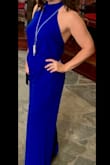 Bought this in my favorite color blue and wore it to my niece's wedding this spring. Got soooo many compliments! I'm 5'2" so had it hemmed and wore it with 4-inch heels. Also wore a stick-on bra since it's backless. A Medium may have worked but I have a booty and like a looser fit. Super comfy material that doesn't show sweat. Great for dancing!! Don't hesitate, buy this jumpsuit! - Karen H.