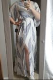 This dress is true to the size. I bought size XL, when I usually wear L, and it was a little too loose, but still beautiful. The underskirt is a little shorter than I would want it to be, so I wore a dress slip on. The dress is light and flowy and even with me being on the heavier side I received A LOT of compliments on how beautiful it made me look. - Natasha G.