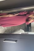 The material was light and flowy. Felt very sexy in this outfit and fits perfectly. I had to get it taken in 1.5" even though I was wearing 3" heels. The zip was a challenge as it bends, just take your time with it. I had to get a V neck bra to prevent any issues and used safety pins to tuck the bra in the back so that it does not show.
The burgundy looks different under the sun - Joyce M.