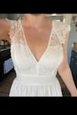 I got this dress for my outdoor wedding in September. It fits absolutely perfectly! It's a few inches too long for me, but I think heels might fix that. This dress is beautifully made, it looks very high-quality. It is bright white which I love! The skirt is flowy & the slit is not too revealing! I was worried because I thought I would need to find a bra with an open back, but I don't think I need one at all. I'm so excited to get married in this dress! - Abby J.