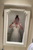 I tried the dress on before I washed it, and it fit perfectly. I followed the care instructions; hand wash cold and line dry. I tried it on again, and the top layer shrank. Graduation is in a few days, and I'm trying to stretch the dress out, so it's long enough to cover the liner. The first photo is after the wash; the second is when I first tried it on. - Kierstann K.