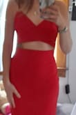 Material is fantastic-it is form fitting but also has a give to it. Hugs in all the right places. The color is the perfect true red. I love the fact I can pull the bottom down a bit if I wanted to show some extra skin, or pull it up to be a tad more conservative. (See photos) Can't wait to wear it to an upcoming party. - Melissa A.