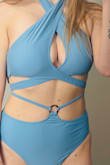 I love the style and color of this top. I do wish the back tied instead of the buckle. I would usually get a large in tops to fit my chest, but this one has a lot of coverage so I went with the medium and so glad I did! The only thing is the band is a TINY bit looser than I would like. I was able to somewhat adjust with the neck tie straps. 34DD, 35" chest, 27" waist. The bottoms (same as model) fit great. I'm [a] standard size medium. The thinner top strap around the waist is adjustable - Charlie W.