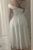 Definitely 50's vibes with a modern twist. This dress fits very well. The one shoulder is not too tight and not too lose. The fabric is heavier weight, a bit stretchy, and hangs nicely. I have wide hips for my frame (see measurements) which can make it challenging to find garments that fit properly, but this dress accommodated. The only bad things were the closures. The hook and eye closure at the top of the zipper came off very easily, so I will have to sew it back in. The zipper is also hard to pull up and down which ended up being kind of a good thing considering the hook and eye issue. I bought this as rehearsal dinner dress and a backup reception dress in case my wedding dress couldn't be bustled. - Natalie R.