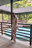 This romper is gorgeous as long as there are no Nip Slips!!
Tips- really tie the back of it tight and keep a semi-decent GOOD POSTURE. If you're sitting or slouching one strange way, the shoulder might slip off. It's a real fear. Wearing a sweater over it will save you in the car and help keep the sleeves up.
It is gorgeous though. Totally worth. Once I got the hang of how to wear it, I got sooo many compliments. Im looking at these pics like wow- stunning >)
I got an XSmall. Fits well and I'm really glad I didn't size up. - Laura D.