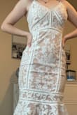 This dress is so pretty and unique! The detailing is lovely. It is quite fitted throughout the hips and legs but a little looser on the top. I would size down if you have a smaller chest, but be careful because there is no stretch in the thigh area! - Tenley J.