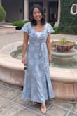 I wore this to my niece's baptism and it was amazing! I love all the details like the shoulder ruffle, bow, embossed flower patches. Two things: 1) it falls like a maxi dress if you are my height & 2) you have to wear a cami/bandeau since it splits wide open in the chest. I didn't mind either one! It's the perfect Sunday dress and I was so comfortable in it. Must get! - Korina C.