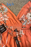 I sized down according to the reviews and the XS fits perfectly. I am usually in between a size small and a medium and while the small would work, the XS looked better. I ordered 3 of these dresses- two in blue (Small and XS) and one orange (XS). I only kept the XS blue. It is a little long but with a heeled shoe, the length is fine.

I ended up returning the orange dress because the print design was barely present on the top of the dress. However, the inside of the top would have been beautiful if it was on the outside. I wish there was better quality control with this. It almost looks like they sewed the top of the dress inside out. - Kristin C.