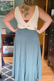 I love this skirt! Material is not flexible but fits fine, sits high waist and the skirt flows beautifully when you walk. Back is long, which works great for a tall person. I've paired with the Lulus sweater tank I got and they look great together! - Kira W.