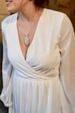 I purchased this for my outdoor November wedding. It fit perfect minus the length, but I am on the shorter side. I got it hemmed for my height but otherwise great fit. I was also almost four months pregnant and was able to hide the bump nicely! - Mary C.