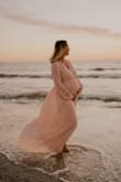 I loved this dress for my sunset beach maternity pictures! I bought my prepregnancy size because I figured the skirt would be flowy enough for my belly at 31 weeks! My bust had grown a couple of cup sizes and it still fit as well, the waist is elastic! It's very comfortable and can wear it when I'm not pregnant too! Highly recommend!!! - Adaline C.
