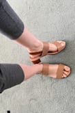 The artificial leather material is really cheap-looking and will likely flake after some use during the summer, but they're very versatile sandals and are cute enough on the foot. Sizing was good as well. - Milly C.