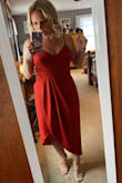I received so many compliments on this dress. It is definitely more of a rust red than a cherry red. It is flowy, comfortable and fit like a glove. The straps are adjustable which is extremely helpful if you do not want to wear a bra. I wore a regular strapless bra and it worked out perfectly. - Nikki W.