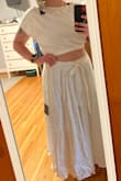 Really loved the fabric and weight of this dress.  Wore it for my very small wedding ceremony.  There was a little inconsistency in the liner showing at the bottom of the skirt.  The skirt material, like others, said is very heavy.  Saw a lot of pictures and the model wearing the tie for the skirt in the front but I had to wear it tied in the back or the skirt would have fallen down.  Was very comfortable, but would probably get a size smaller if I had had the time. - Jaelle B.